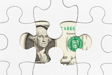 US Dollar Banknote Hidden Under Puzzle Financial Concept