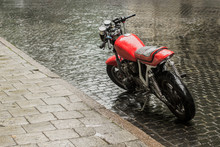 Parked Red Wet Motorcycle Under The Rain