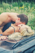 © M-Production - Sensual couple making love on the car's hood.
