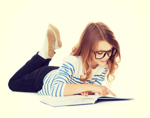 Canvas Print - smiling little student girl lying on the floor