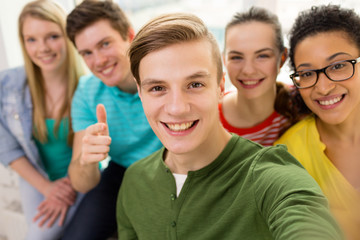 Poster - five smiling students taking selfie at school