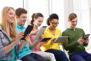 Wall Mural - smiling students with tablet pc at school