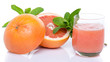 Glass of grapefruit juice with fresh grapefruits and mint