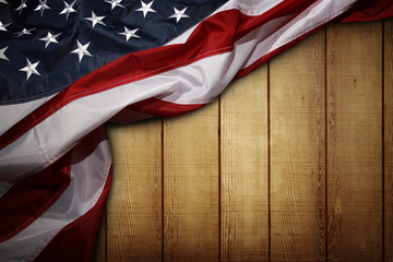 Poster - American flag on brown wooden boards wall background. Copy space