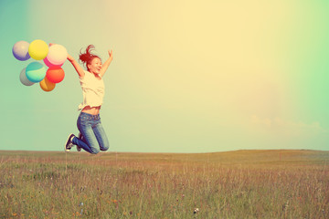 Poster - young asian woman on green grassland with colored balloons 