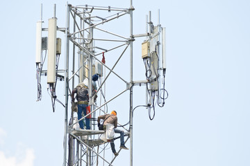 Wall Mural - Technician working on communication towers