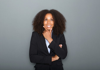 Wall Mural - Confident young business woman thinking on gray background