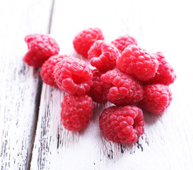 Ripe sweet raspberries on table close-up