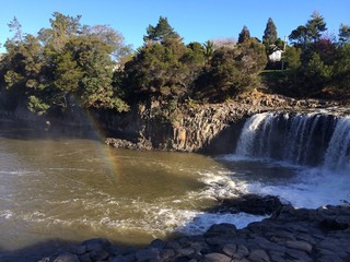 Haruru falls with a rainbow in new zealand 