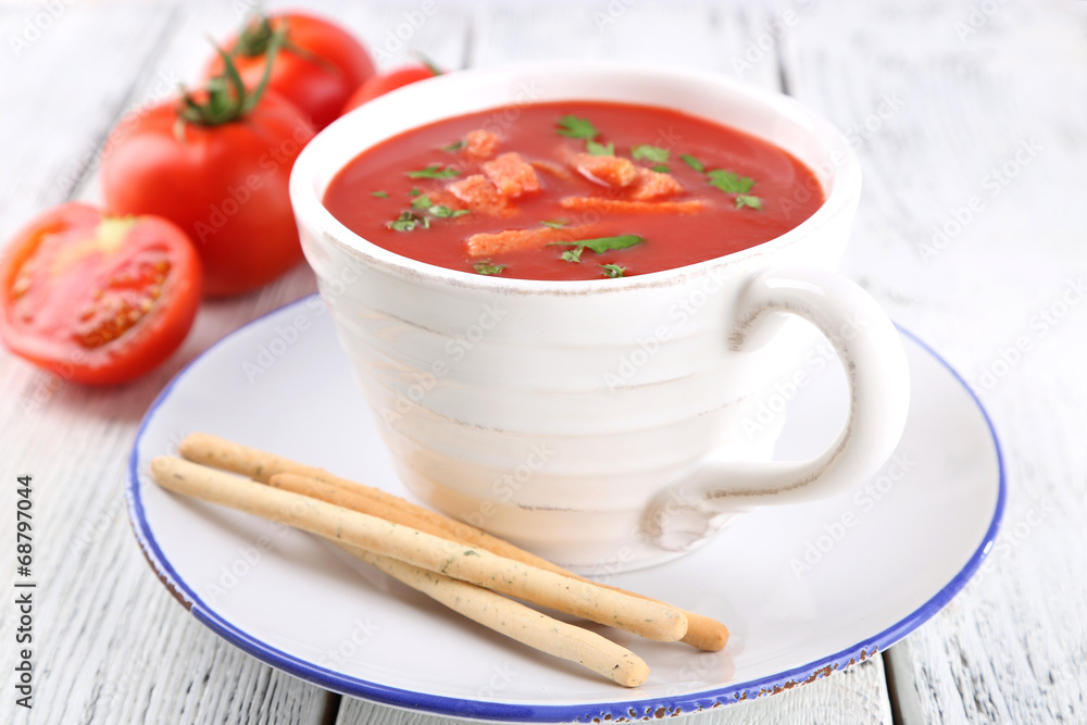 Tasty tomato soup with croutons on table close-up