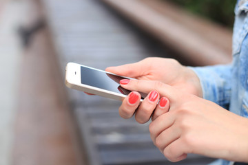 Wall Mural - Close up of a woman using mobile smart phone