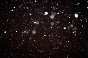 Wall Mural - snow bokeh texture on black background