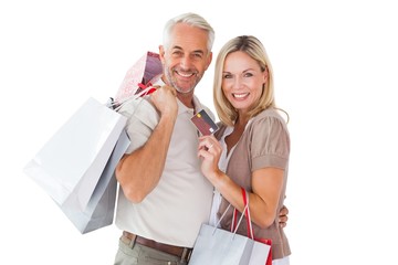 Wall Mural - Happy couple holding shopping bags and credit card