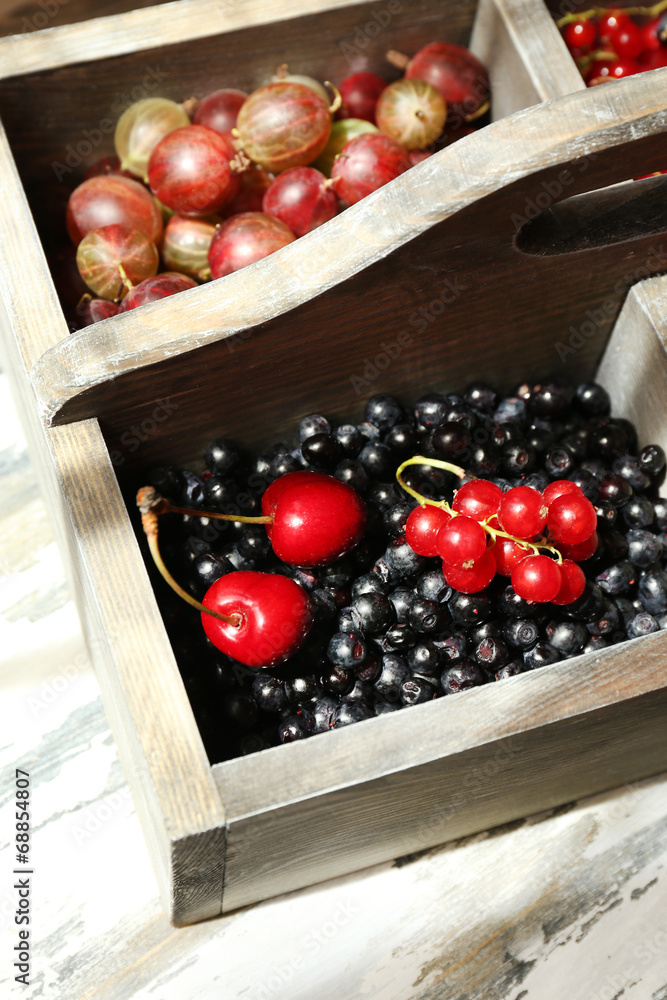 Fresh berries in wooden box, close up