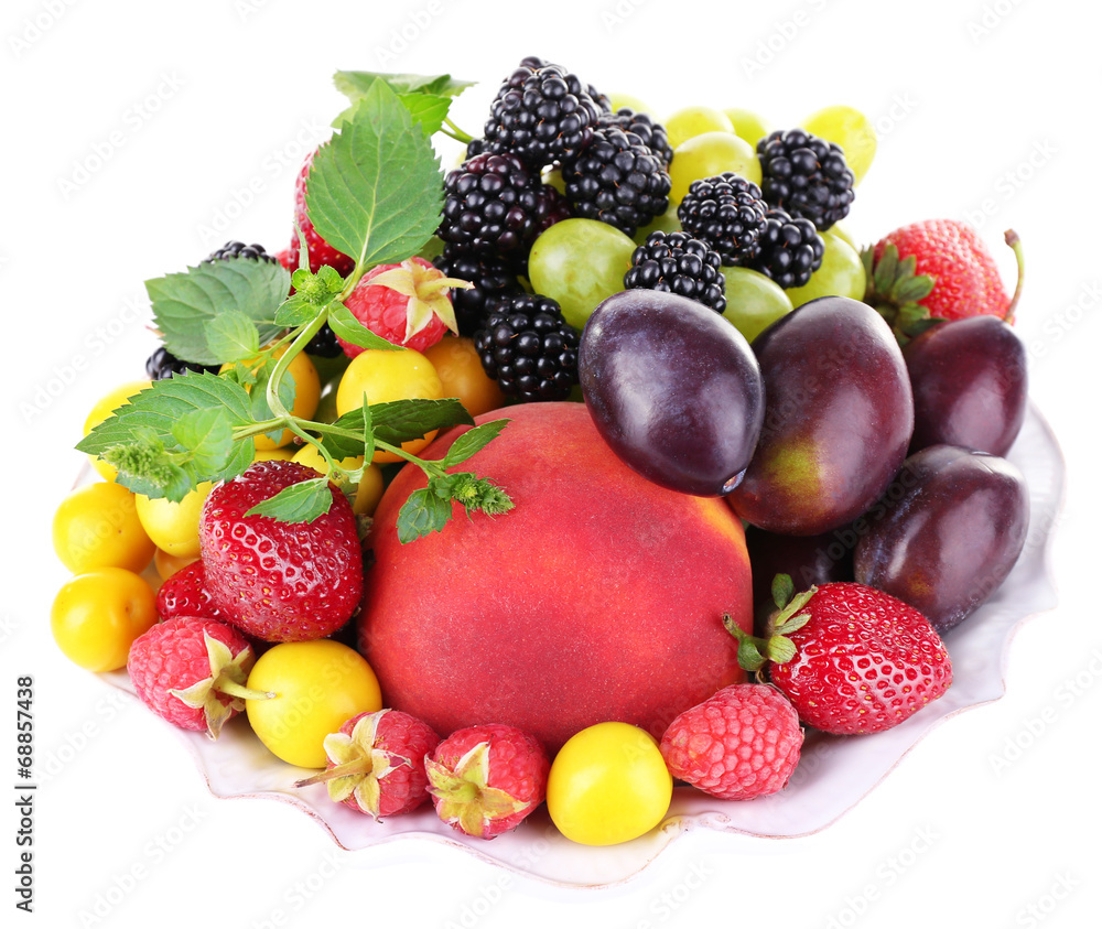 Different berries and fruits in plate isolated on white