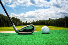 Close-up Of A Golf Ball And A Golf Iron On A Driving Range