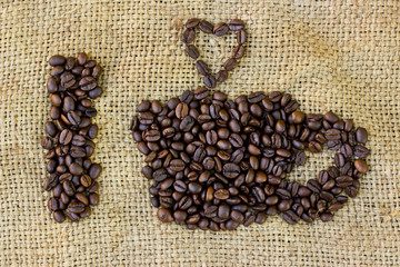 Wall Mural - I love coffee symbols made of coffee beans on sack background