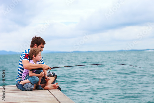 Fotografija  Father and son fishing together