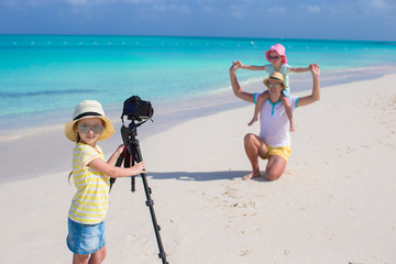 Wall Mural - Little cute girl making photo of her family