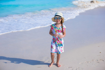 Wall Mural - Adorable little girl at white beach during summer vacation