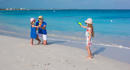 Sticker - Little girl playing with family at the beach