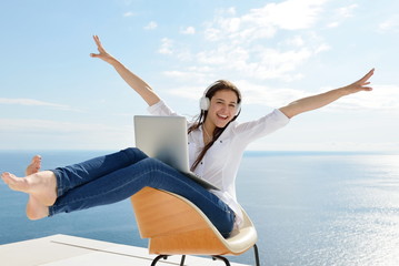 relaxed young woman at home working on laptop