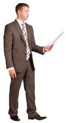 Wall Mural - Standing businessman looking at paper sheet