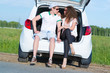 © adam121 - young couple sitting in the open trunk