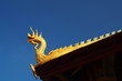 Naga structure decoration on gable of Laos temple in blue sky