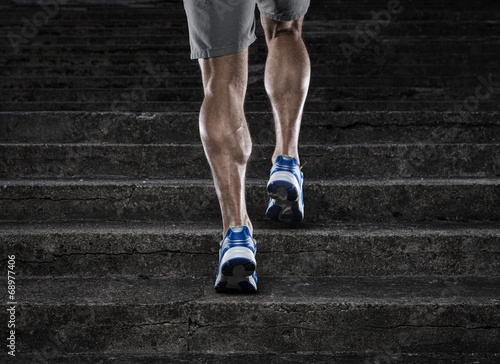 Fotomural Close up of young man running up the stairs