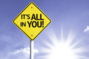 It's All In You road sign with sun background