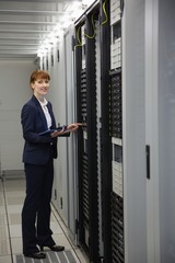 Wall Mural - Technician working on servers using tablet pc