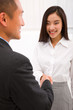 © Ambrophoto - Businesswoman shaking hand with businessman