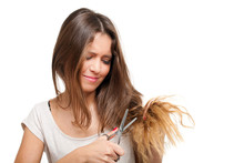Young Woman Looking At Split Ends