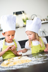 Wall Mural - happy children kids family preparing funny cake kitchen at home