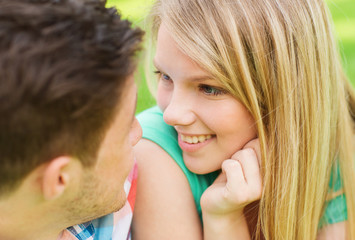 Wall Mural - smiling couple looking at each other in park