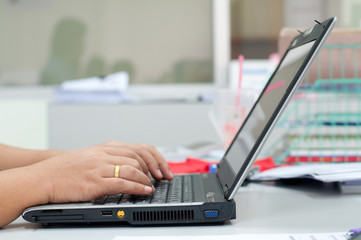 Closeup of businesswoman typing on laptop computer