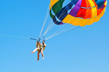 Poster - people parakiting on parachute in blue sky