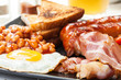 Full English breakfast with bacon, sausage, egg and beans