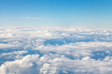 Wall Mural - horizon above white clouds in blue sky