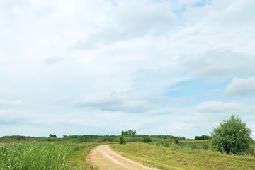 Sticker - blue rainy clouds over country road