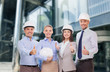 © Syda Productions - happy business team in office showing thumbs up