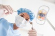 Dentist in surgical mask and cap
