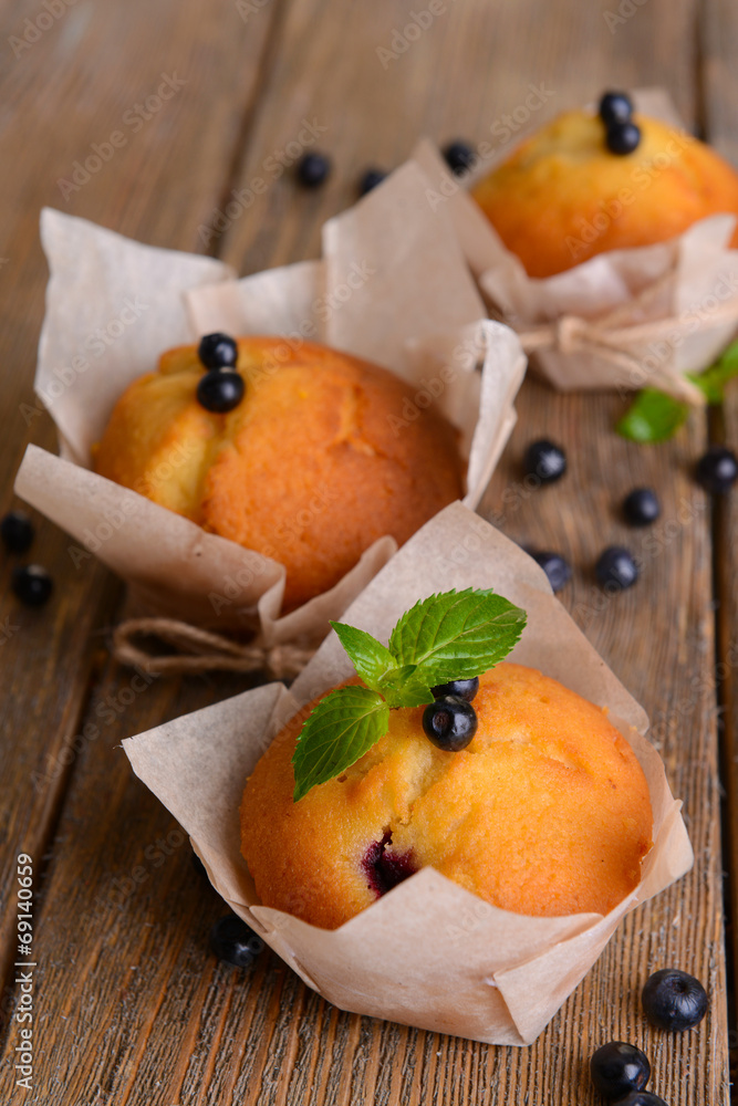 Tasty cupcakes with blueberries on table close-up