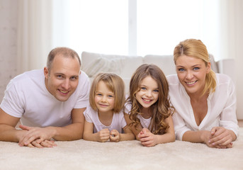 Poster - parents and two girls lying on floor at home