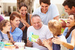 © Monkey Business - Multi Generation Family Celebrating Birthday In Garden