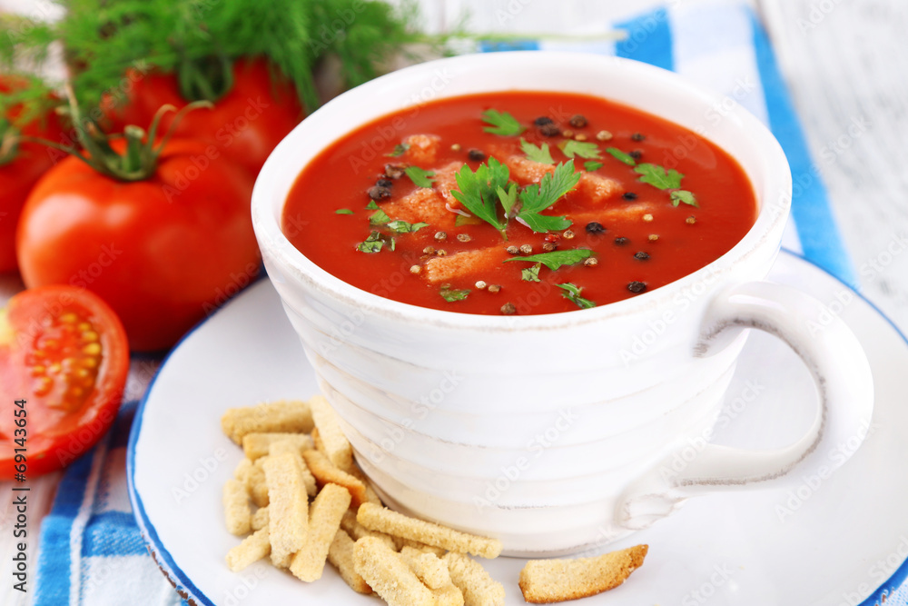 Tasty tomato soup with croutons on table close-up