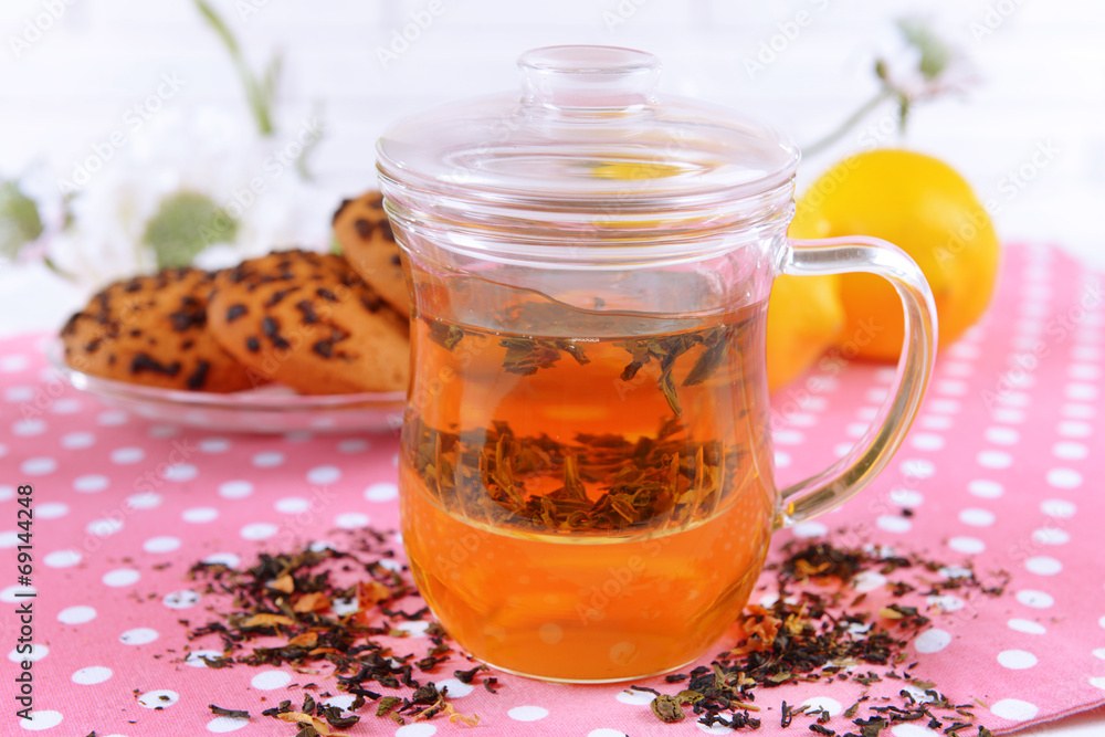 Cup of tea on table on brick wall background