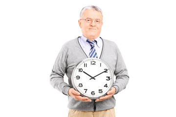 Poster - Senior gentleman holding a big wall clock