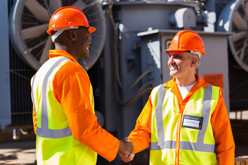 power company co-workers hand shaking